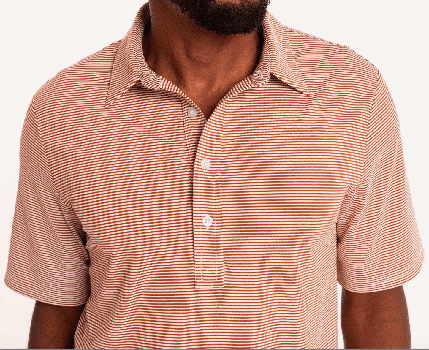 Criquet Performance Sport Range Polo in Hobby Stripe Burnt Orange
